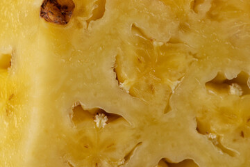 ripe pineapple of yellow-orange color cut into pieces