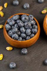 blueberries in a wooden bowl on the table
