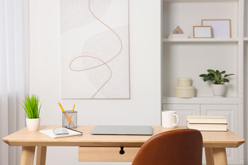 Home office. Stylish workplace with laptop and stationery on wooden desk indoors