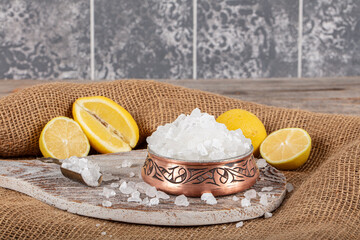 Lemon salt or Citric acid on wood background. Citric acid or lemon salt in wooden bowl. Lemon salt for cooking on wooden background.