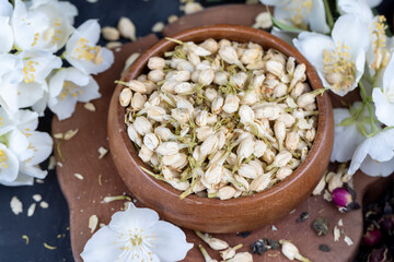Obraz na płótnie Canvas dried jasmine flowers and buds for adding to tea