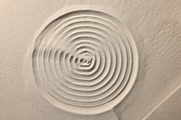 Fototapeta na wymiar Beautiful spiral on sand, top view. Zen garden