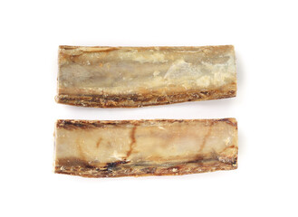 Real dog beef bones for dog dental health and chew fun. Group of center cut cattle rib for medium sized dog. Used as snack, reward and mental enrichment. Selective focus. White background.