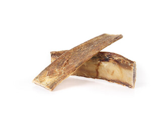 Isolated dog beef bones for dog dental health and chew fun. Group of center cut cattle rib for medium sized dog. Used as snack, reward and mental enrichment. Selective focus. White background. - obrazy, fototapety, plakaty
