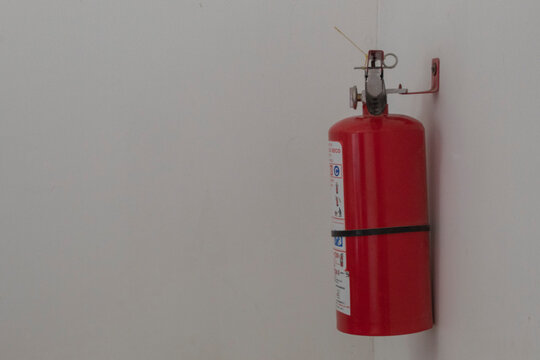 Extintor rojo con fondo blanco