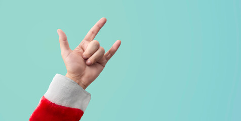 hand of a person dressed as santa claus gesturing sign of love and rock