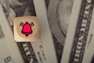 Money banknotes with a bell symbol signaled urgency within the economic situation, prompting swift...
