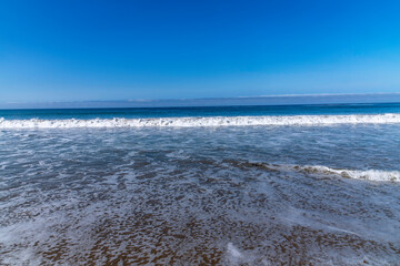 Waves break on the beach at Jalama Beach in Lompoc, CA.