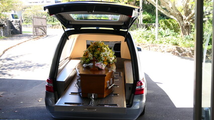 closeup shot of a funeral casket or coffin in a hearse or chapel or burial at cemetery
 - obrazy, fototapety, plakaty