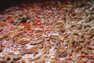 Cook banana peel vegetables with orange seasoning in a large cauldron while boiling.