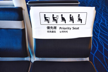 Selective focus of priority seat sign in multi language. - obrazy, fototapety, plakaty