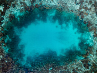 coral reef in the blue sea deep blue hole aerial shot in Australia