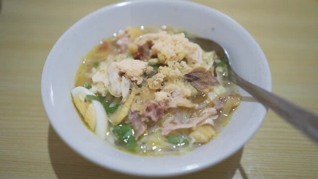 A bowl of Soto Koya Lamongan, Indonesian food curry with chicken meat and vegetables originally from East Java