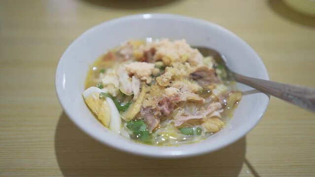 A bowl of Soto Koya Lamongan, Indonesian food curry with chicken meat and vegetables originally from East Java