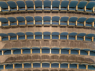 Overhead view of empty gray and blue theater, auditorium seats, chairs.
