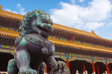 Old imperial lion sculpture in front of historical Forbidden City buildings