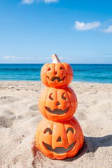 Beach Halloween background with three pumpkins - 653088907