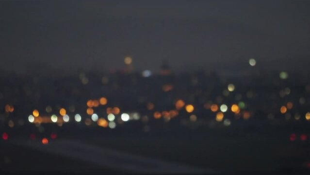 Blurry city lights in the night. Colorful bokeh with city lights in the background. Selective focus, night life, atmospheric mood. Cluj city lights.