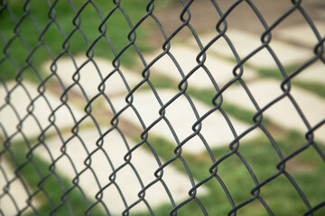 Chain link fence in outdoor background.