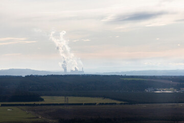 Smoke from Tall Smokestacks Spreading into the Atmosphere