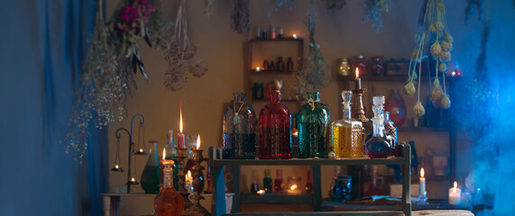 magic potions in witch's house with burning candles at night