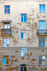 Fragment of the facade of an old apartment building on an autumn day