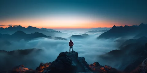 Foto op Canvas A Mountain Climber standing on top of a mountain looking at the horizon on a snowy landscape at sunset . Mountain Climber Conquering the Summit at Sunset © Maria