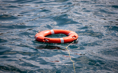 red lifebuoy on the water in the sea