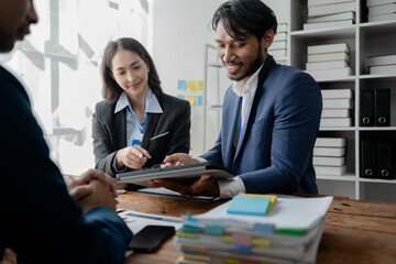 A group of businessmen and marketers meet in a company meeting room, a group of investors and executives plan marketing plans to find ways to make profits and grow. Marketing planning meeting ideas.