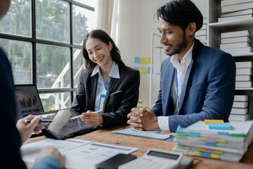 A group of businessmen and marketers meet in a company meeting room, a group of investors and executives plan marketing plans to find ways to make profits and grow. Marketing planning meeting ideas.