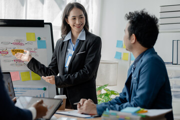 A group of businessmen and investors are meeting to invest in a business, conference room atmosphere with businessmen presenting meeting documents. Venture capital concept and business meeting.