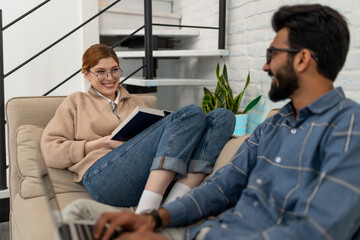 Young couple spending free time at home on internet