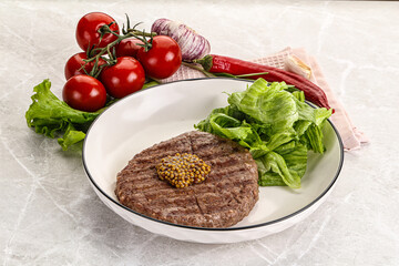 Frilled beef burger cutlet with iceberg