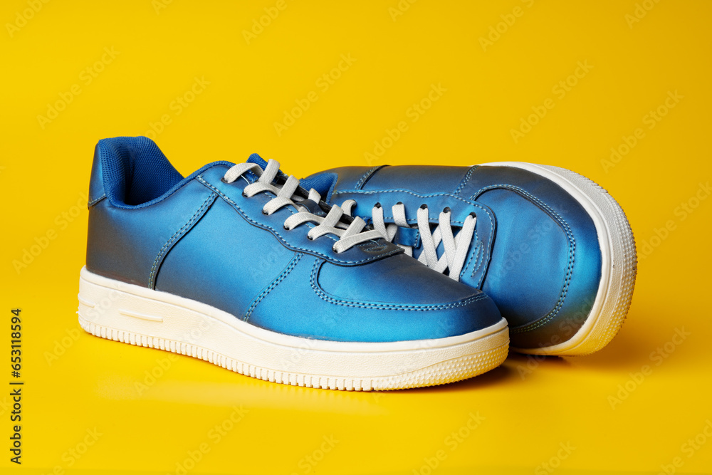 Poster Blue new sneakers on yellow studio background