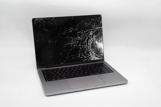Broken LCD display on laptop computer. Isolated white background.