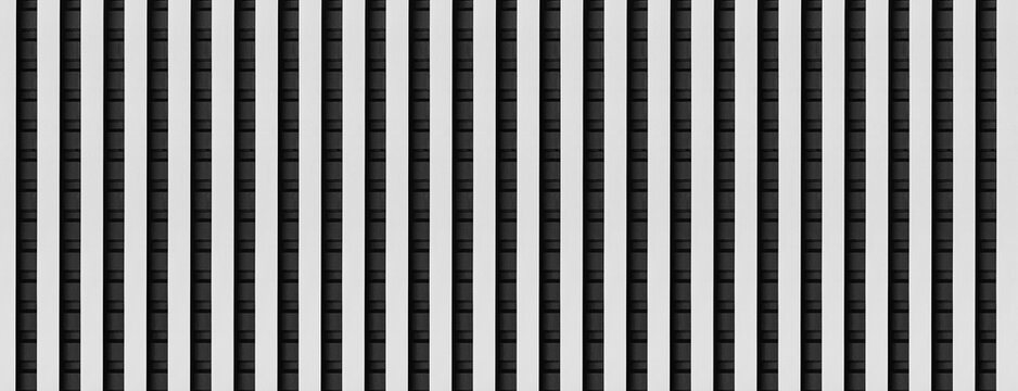 white and black metal siding fence striped background