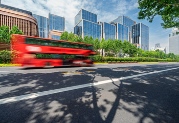 financial buildings in the Bund of Shanghai and moving bus on the highway