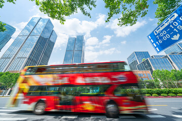 financial buildings in the Bund of Shanghai and moving bus on the highway