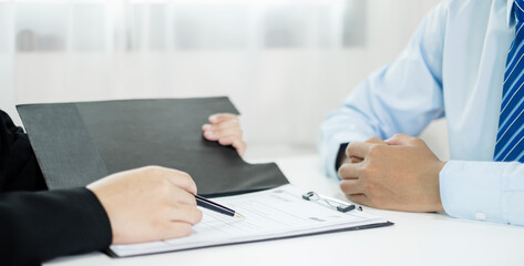 Business people hold a resume and talk to job applicants for job interviews about careers and Their personal history in the company. Recruitment concepts