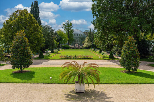 French garden of the Jardin des Serres d'Auteuil with a Greenhouse in the background. This botanical gaden is a public park located in Paris, France