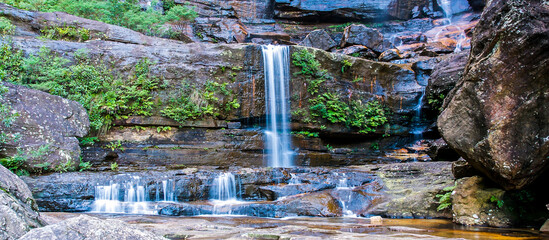 The Queen's cascades waterfall located at Wentworth Falls in the Blue Mountains of New South Wales. This has been shot with a slow shutter speed so the water is feathery. © Daniel