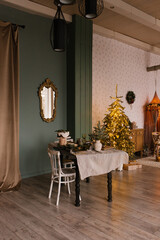 Fototapeta na wymiar Stylish Christmas living room with a festive dining table decorated for Christmas Eve