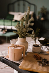 Branches of spruce or fir in a ceramic vase on a festive table decorated for Christmas