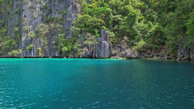 Drone Footage at Twin Lagoon in Philippines. Low flight strating in the center of the lagoon to go to the exit. Beautiful cliff and turquoise water.