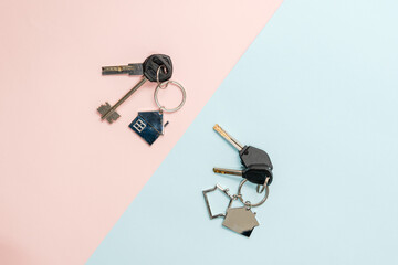 Keys with keychain with shape of house on two colored background