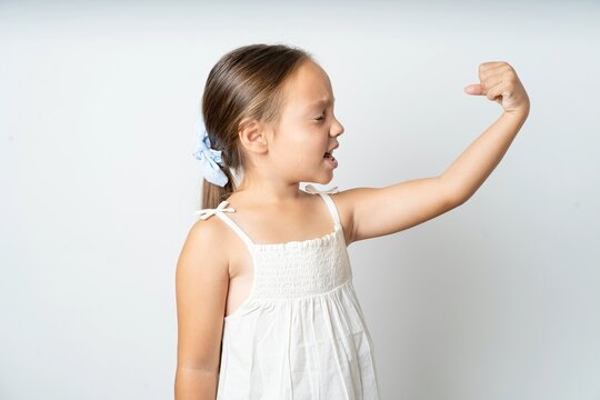 Profile photo of beautiful kid girl wearing white dress supporting soccer team raise fist shouting
