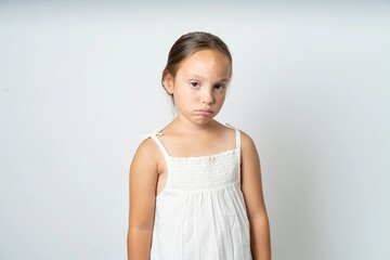 beautiful kid girl wearing white dress depressed and worry for distress, crying angry and afraid....