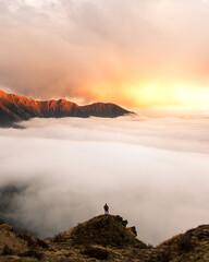 a sea of cloud rolling into the himalayas, nepal at sunset