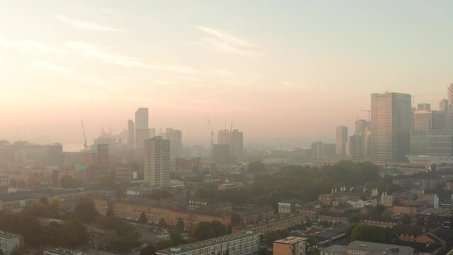 Aerial shot over Poplar London in the mist at sunrise