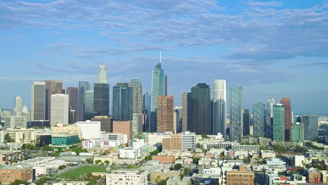 Drone left to right establish panoramic los angeles california skyscraper buildings, dramatic grey cloudy sky